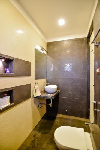 a bathroom with a toilet and a sink at Lifeline Villas - Luxurious Taraangan 4 Mountain View Villa With Biggest Pool And Huge Open Area in Lonavala