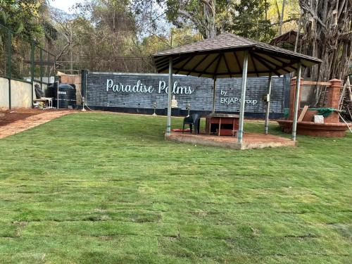 a gazebo with a sign that reads poncho rhinos at 360 Bliss Dia Hotels in Nerul