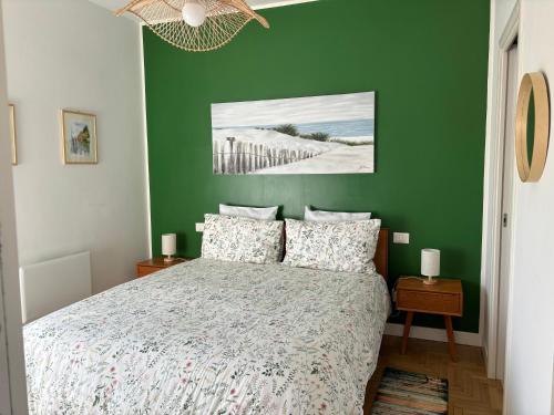 a green bedroom with a bed and a green wall at Aurelia Garden in Rome