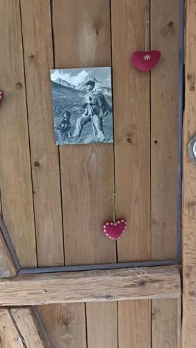 a picture of a man hanging on a wooden wall at Charmant meublé classé 3 étoiles dans ferme du XIXe restaurée in Le Hohwald