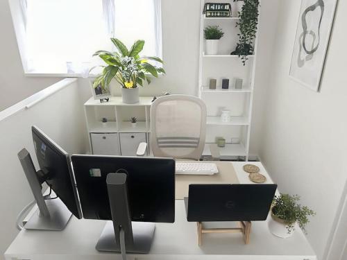 an office with a desk with a computer on it at Private guest house - Double bedroom, en-suite and workspace with private entrance, first floor with no lift and no full kitchen in Leicester