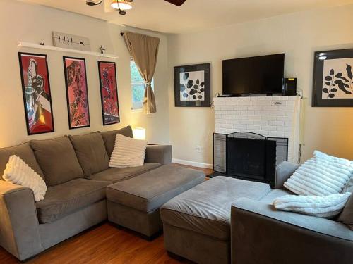 a living room with a couch and a fireplace at Family Friendly Home in Seaside
