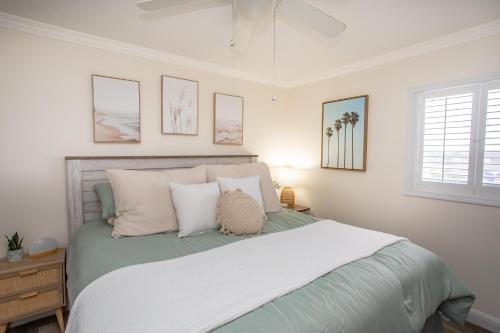 a bedroom with a large bed with white walls at Waters Edge in Myrtle Beach