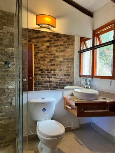 a bathroom with a toilet and a sink at Termales azules La Calera in El Salitre