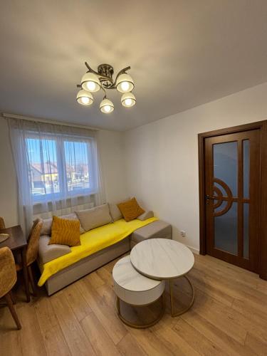 a living room with a couch and a table at Best choice flat in Târgu-Mureş