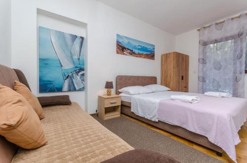 Posteľ alebo postele v izbe v ubytovaní Apartments Tabak