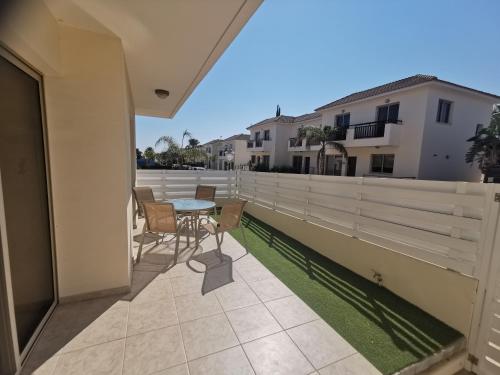 a patio with a table and chairs on a balcony at Beach bliss apartment in Protaras
