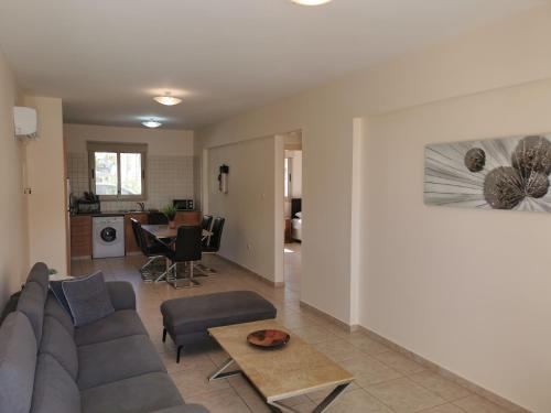 a living room with a couch and a table at Beach bliss apartment in Protaras