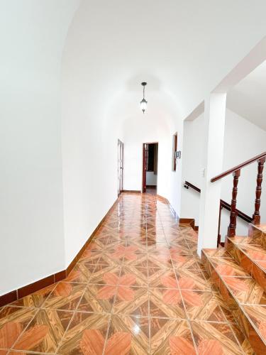 an empty hallway with a tile floor and stairs at Casa Balam Bed & Breakfast Boutique in Ciudad Vieja