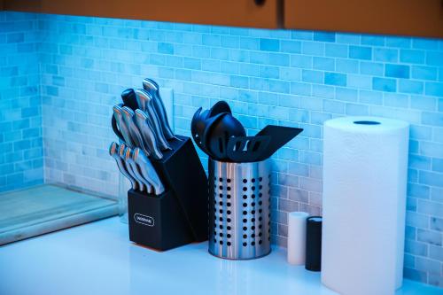 a container of utensils sitting next to a roll of toilet paper at 1bedequippedkitchenhighfallstvdtwi-fi in Rochester