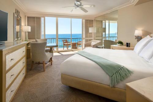 a hotel room with a bed and a view of the ocean at Surf and Sand Resort in Laguna Beach