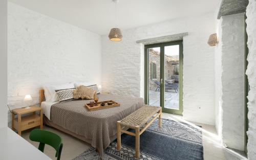 a bedroom with a bed with a tray on it at Triad Villas in Ioulis