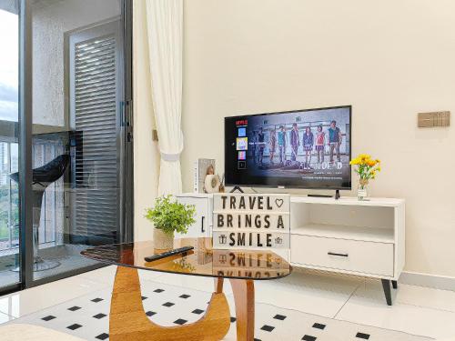 a living room with a tv and a glass table at Bukit Indah 1/Studio/Aeon Mall in Johor Bahru