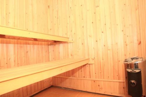 a corner of a wooden room with a shelf and a toilet at Yellow Hostel Dushanbe in Dushanbe