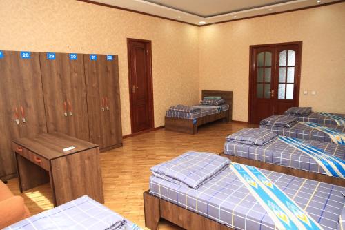 a room with four beds and lockers in it at Yellow Hostel Dushanbe in Dushanbe
