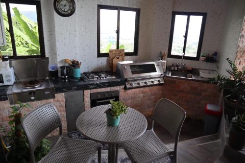 a kitchen with a table with chairs and a stove at 180 Degrees Self-Catering in Victoria