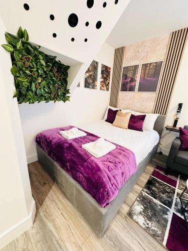 a bedroom with a large bed with purple sheets at Newly renovated luxury Private En-Suite Room in Harborne Park Road - Birmingham R3 in Birmingham