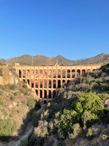 a bridge in the middle of a mountain at Lovely studio Nerja ground floor in Nerja