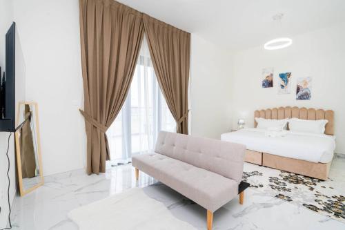a bedroom with a bed and a chair at Spacious One Bedroom Apartment in Dubai
