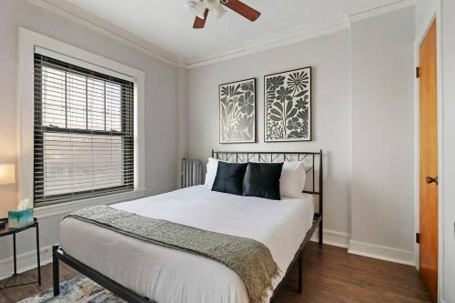 a bedroom with a bed and a window at 1BR Stylish & Modern Chicago Apartment - Kenwood 508 rep in Chicago