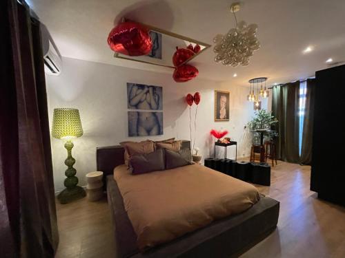a bedroom with a bed with red flowers on the wall at Love room Casa Amore sauna balnéo 66 Occitanie in Prades