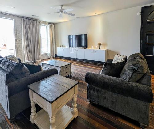 a living room with two couches and a coffee table at Cherry Street Luxury Apartment in Helena
