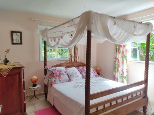 a bedroom with a bed with a canopy at Gîte chez Marie in Saint-Claude