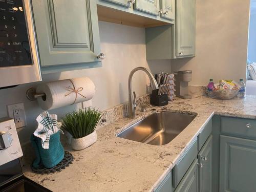 a kitchen with a sink and a counter top at Destin Bliss! Your Dream Studio Condo on Holiday Isle! in Destin