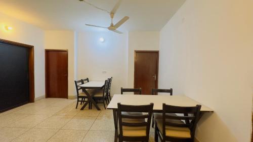 a dining room with a table and chairs at Chittagong Hotel & Apartment Service in Dhaka