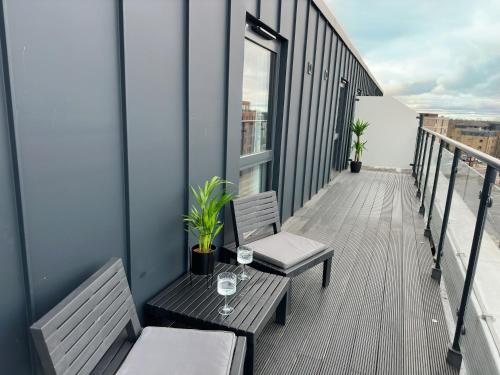 a balcony with two chairs and a table on a building at Luxury York Minster Penthouse - Free Gym & Parking in York