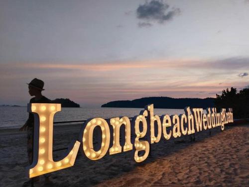 a sign on the beach with the words i love beach at Long Beach Club Krabi in Ao Nang Beach