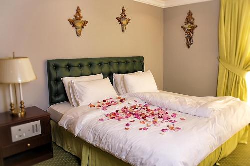 a bed with a bunch of flowers on it at Carlton Tower Hotel Kuwait in Kuwait