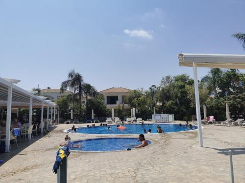 a group of people in a swimming pool at Beach bliss apartment in Protaras