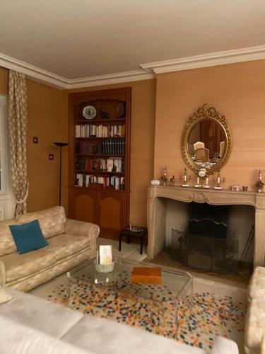 a living room with a couch and a fireplace at Demeure de prestige in Varennes-sur-Allier