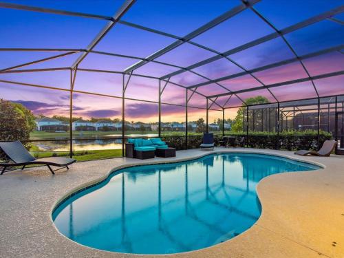 a swimming pool with a pergola and a patio at 6BR w Heated Pool + 9MI to Disney + Sleeps 14 in Kissimmee