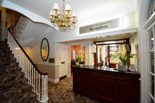 a large room with a staircase leading to a dining room at The Crescent Hotel in Scarborough