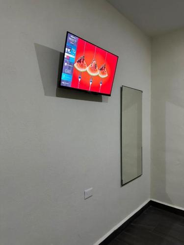 a flat screen tv on a wall in a room at REGMAR Progreso Yucatán in Progreso