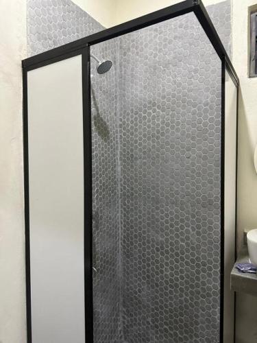 a shower with a glass door in a bathroom at REGMAR Progreso Yucatán in Progreso