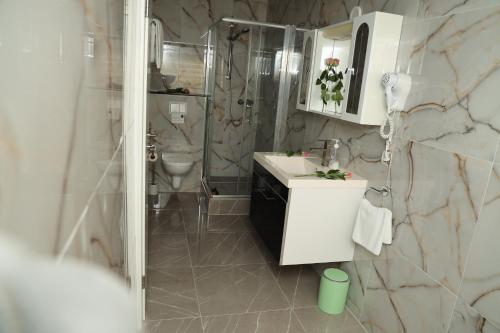 a bathroom with a toilet and a sink and a shower at Hotel Royal in Bad Salzuflen