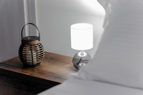 a lamp and a vase on a wooden table at Orizzonte in Lixouri