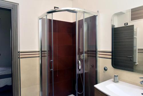 a shower with a glass door in a bathroom at In Terrazza Da Giusy in Rome