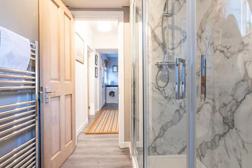 a bathroom with a shower with a glass door at The Tartan Terrace in Inverness