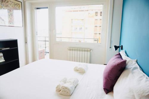 a bedroom with a white bed with towels on it at Appartamento vista San Pietro in Rome