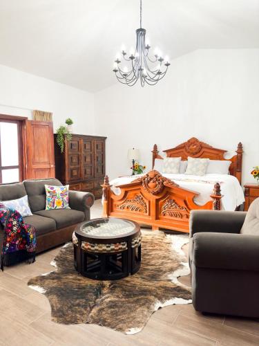 a living room with a bed and a coffee table at Casa Balam Bed & Breakfast Boutique in Ciudad Vieja