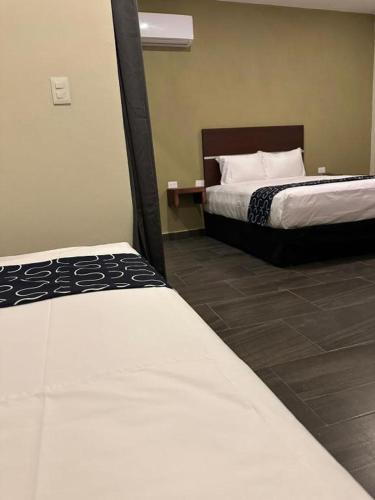 a hotel room with two beds at REGMAR Progreso Yucatán in Progreso