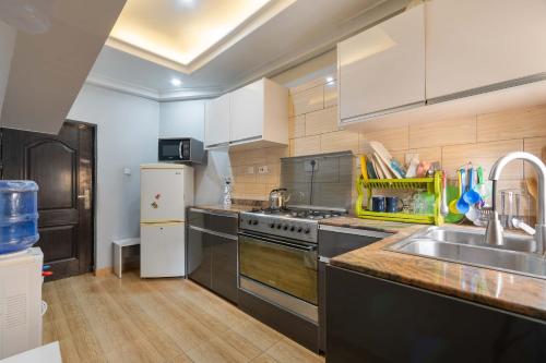 a kitchen with a sink and a stove top oven at Tastefully Furnished 3 Bedroom apartment in Lekki