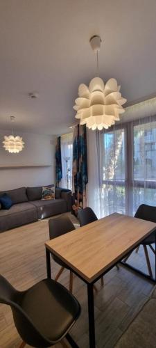 a living room with a wooden table and chairs at Studio CASCADAS FAMILY RESORT in Sunny Beach