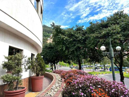 a sidewalk with flowers and plants next to a building at Hotel Bogotá Regency Usaquén in Bogotá