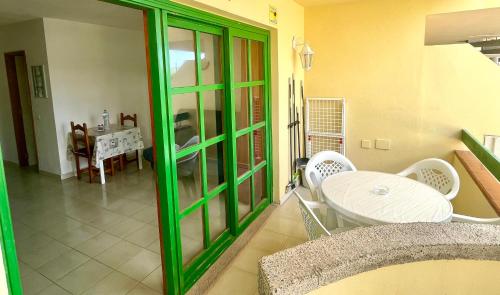 a dining room with a white table and white chairs at Sunlight apartment in Costa de Antigua in Costa de Antigua