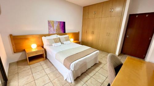 a hotel room with a bed and a table at Napa Gem in Ayia Napa